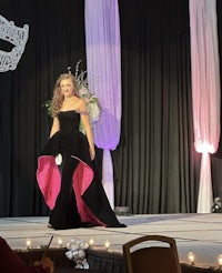 a woman in a black dress on a stage