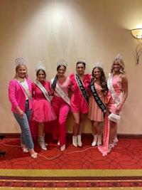 a group of women dressed in pink posing for a photo