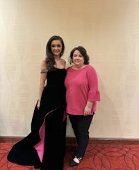 two women standing next to each other in a room