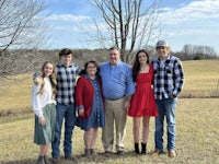 a family posing for a picture in a field